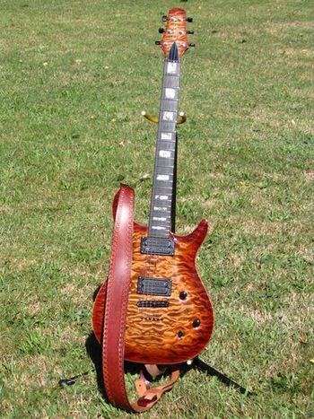 My Number Two. A Carvin CT-6 California Carved Top, stock. Sure, the quilted maple top is like three-dimensional satin, but the tone is to die for. A definitive humbucker voice coming through the classic maple top/mahogany body. Fretwork and an out-of-the-box setup are further testament to Carvin's goal of putting custom instruments directly into the hands of musicians. You can hear this guitar transmitting the lead melody on "Sweet Hollow Road."
