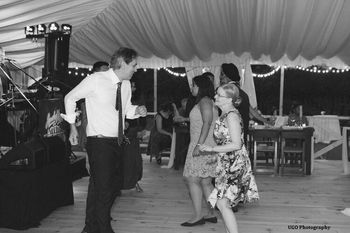 Dancing in front of Sandy Vine And The Midnights at a tented wedding reception.
