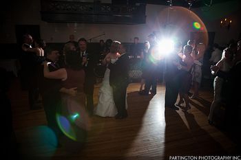 Bridal couple dancing with their parents.
