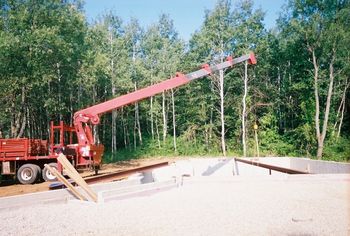 beam that spans the width of the house is set.
