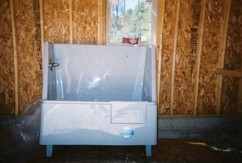 grey color dog bath with door for dog entry.
