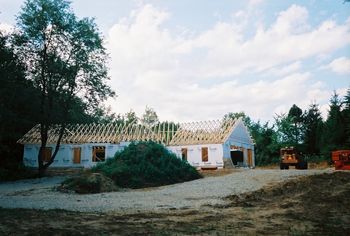 front of house with stockpiled topsoil
