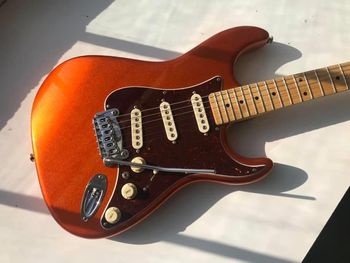G&L S500 in tangerine metallic. I call her Sunshine. This color scheme screams 'Funk' to me.
