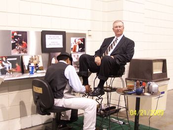 Ole Ern getting his shoes shined. Looks like he's about asleep!
