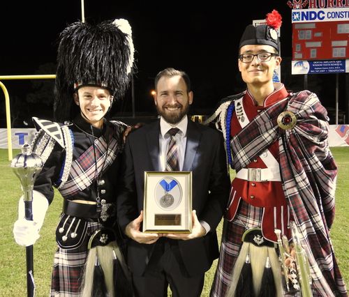2019 Award Winning Kilties: Drum Major, Adam Putney; Mr. Dubbert, Director of Bands; and Alex Garcia, Band Captain.