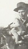 Frank with Packy or Lute, one of two white German sheppard puppies that Gregory Peck gave to Ralph McCutcheon after making the movie 'Duel in the Sun'. 'Dice', a striking black overo pinto stallion, Ralph's first picture horse, was riden by Peck.
