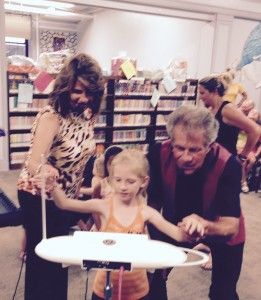 Letting children play our Theremini after a show in a library Buffalo and Brandy

