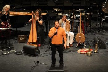 Post Cards from Africa at The River Run Centre. Gary Diggins with spoken word artist Kevin Sutton and Ondine Chorus. Photo: Lewis Melville.
