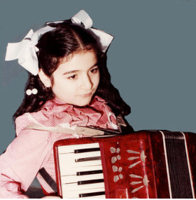 Lina picked up the accordion at age 7, in Kuwait while she was attending the only private Catholic School in the city. This instrument was part of the school curriculum, and one of very few instruments offered.
