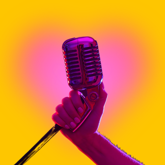 Inner Wild Voice Studio, hand holding a microphone
