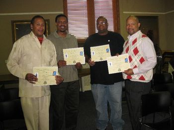 Distinguished men of the community read to the young males.
