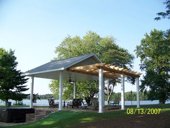 This pavilion has a generous patio space with ceiling fan A fire pit under the pergola and a spa
