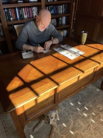 Signing "Don't Mind Me" CDs with my dog Graham

