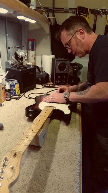Pat fixing up Shane's guitar. This guy knows his shit.
