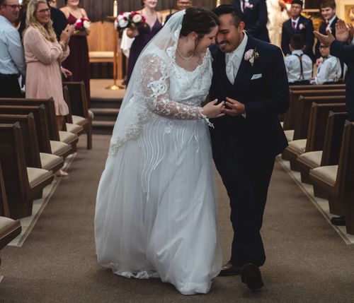 Omar and Jenna Blanco walking down the aisle after ceremony