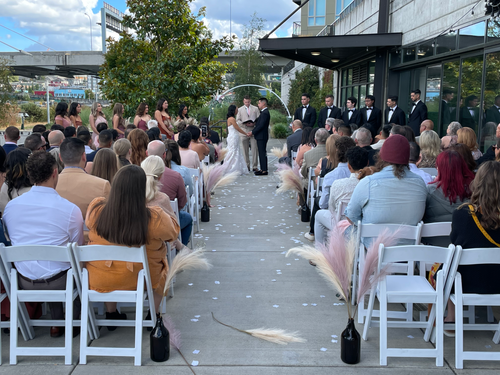couple at the alter and guests sitting down during ceremony