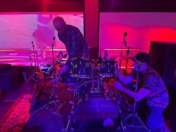 Troy and "sound guy Pete" setting up drum pics for the Palasad Social Bowl 2022 concert.
