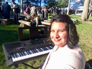 Playing a mix of music, including a specially requested song from a Japanese anime film, for an outdoor country wedding ceremony near Boston
