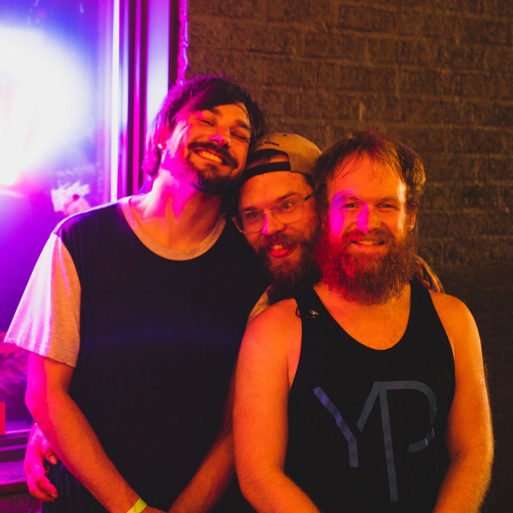 Roy Kirby, Chris Davis, and Justin Pine of Jenn's Apartment outside Mac's Bar in Lansing, Michigan.