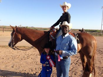 Tayler Kuhn on Zippin Cat taking first place in the Under 13 Western Pleasure. Pictured with Robert and Kiley.
