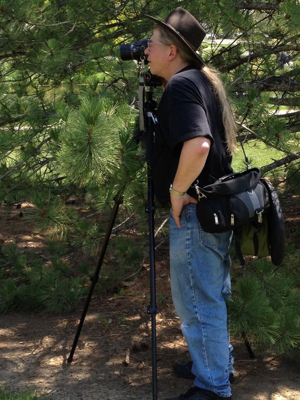 Daniel D. Ellis shooting photos at Loveland CO sculpture show and remembered for his many years of contribution to the ARTistic Pursuits brand. 