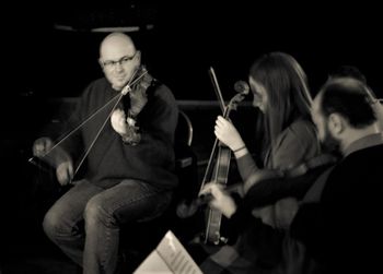 Colin demonstrating some bowing techniques to a couple of students
