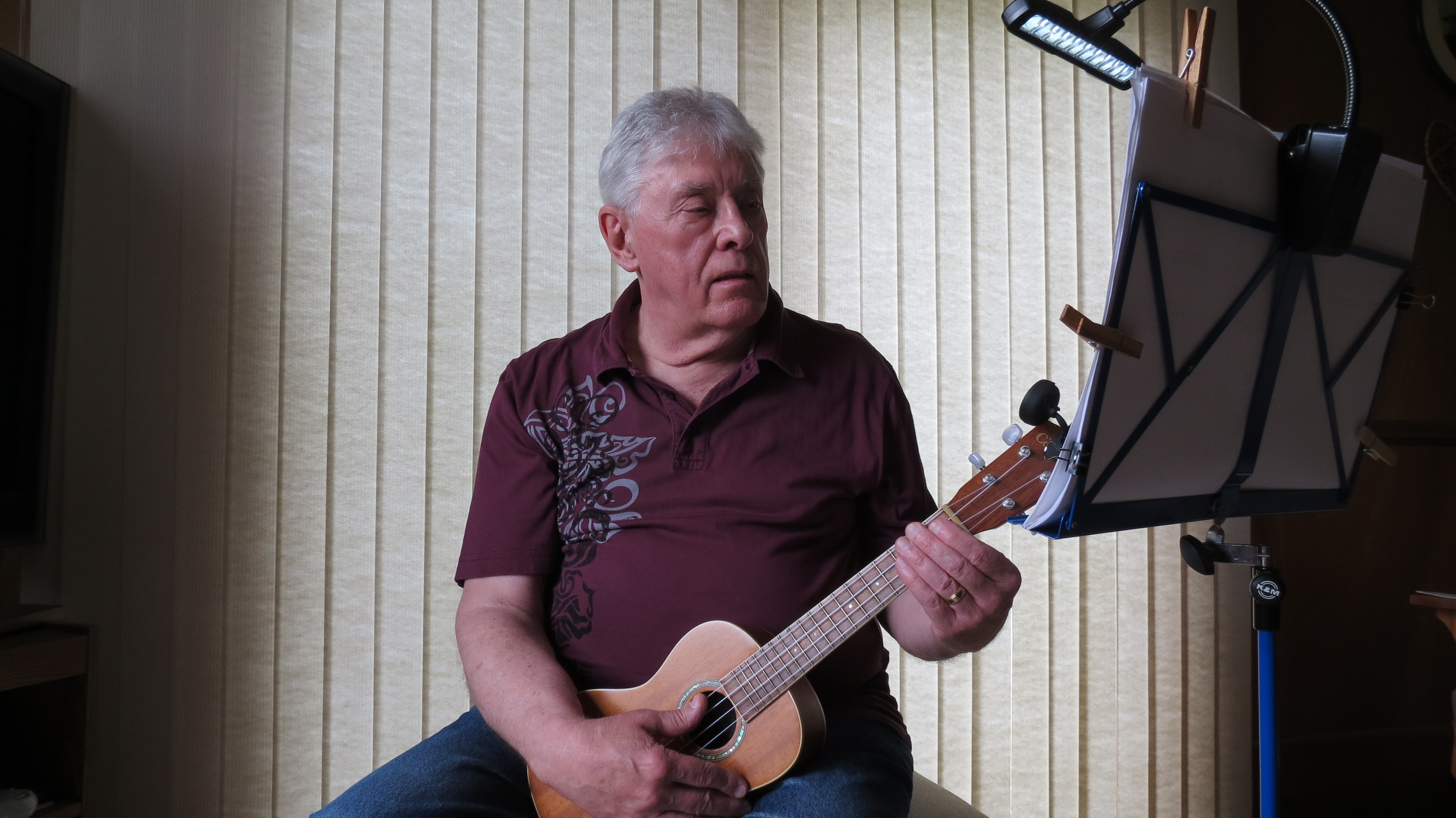 Songdog music student with ukulele in home studio