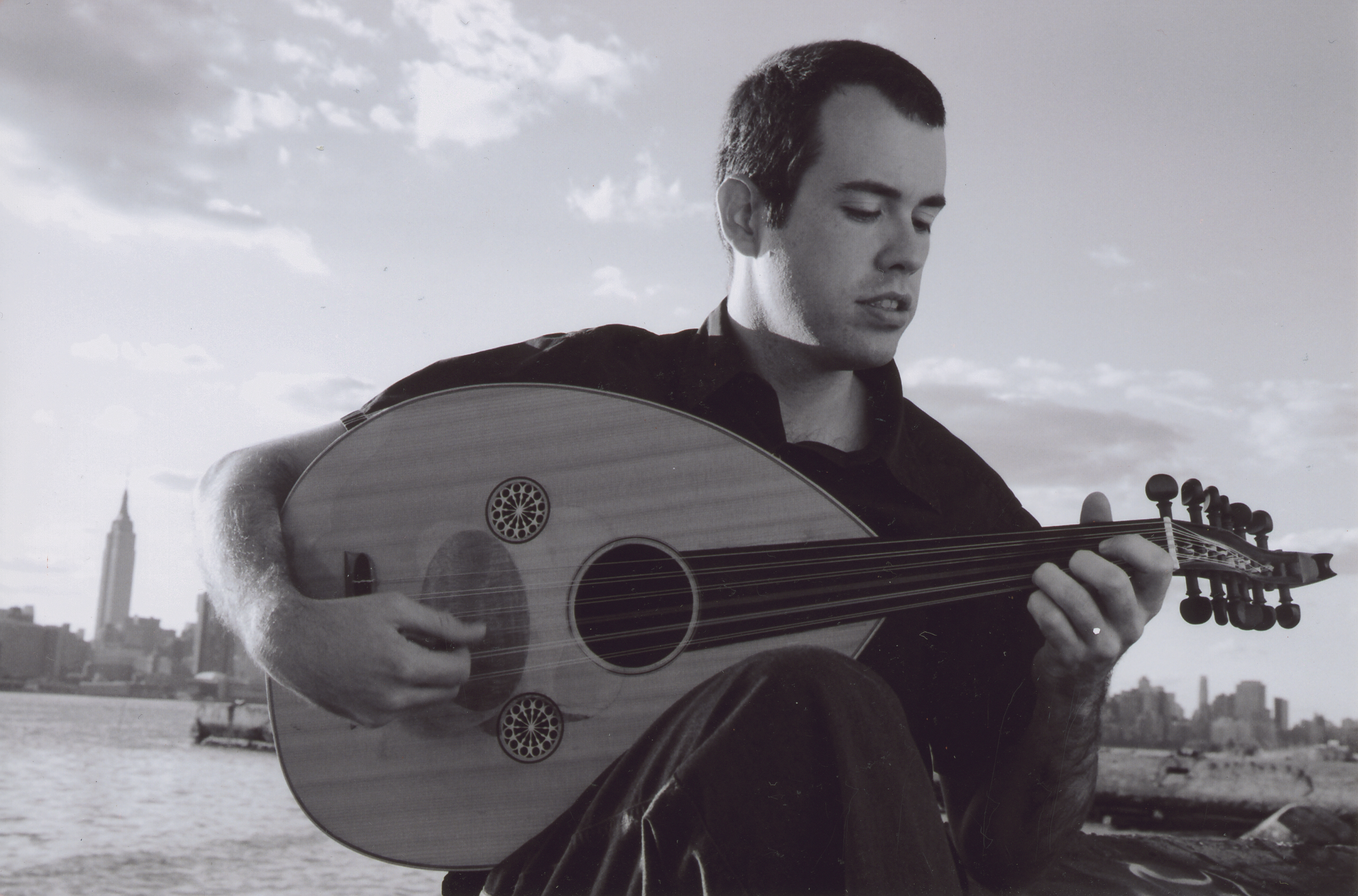 Brian Prunka playing oud by the East River in 2004, shortly after moving to NY