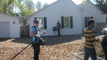 Sound engineer with director,setting up the next scene with Michael at the water hose

