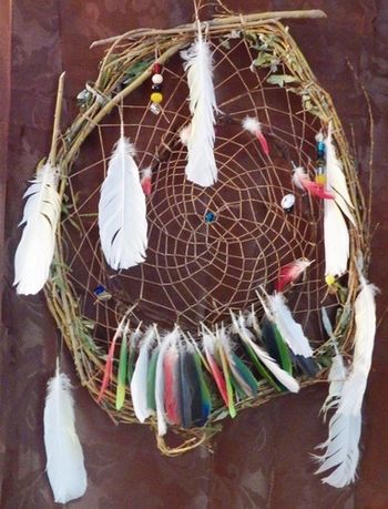Made from willow branches and from parrot feathers, this dream catcher was made for a good friend using his feathers. There are colours of each nation, and memories of his past life on this dreamcatcher.
