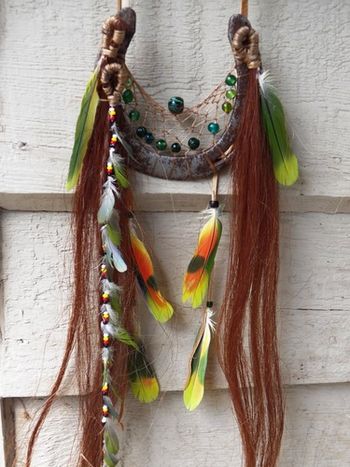 Close-up of July 2012 dream catcher. I used green beads and grean/yellow feathers in this one as the owner was partial to green for her horse. I was given a lot of hair so I could make three strands, one which was braided and green feathers were added.
