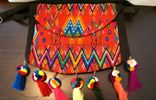 Red multicolored purse with pom poms