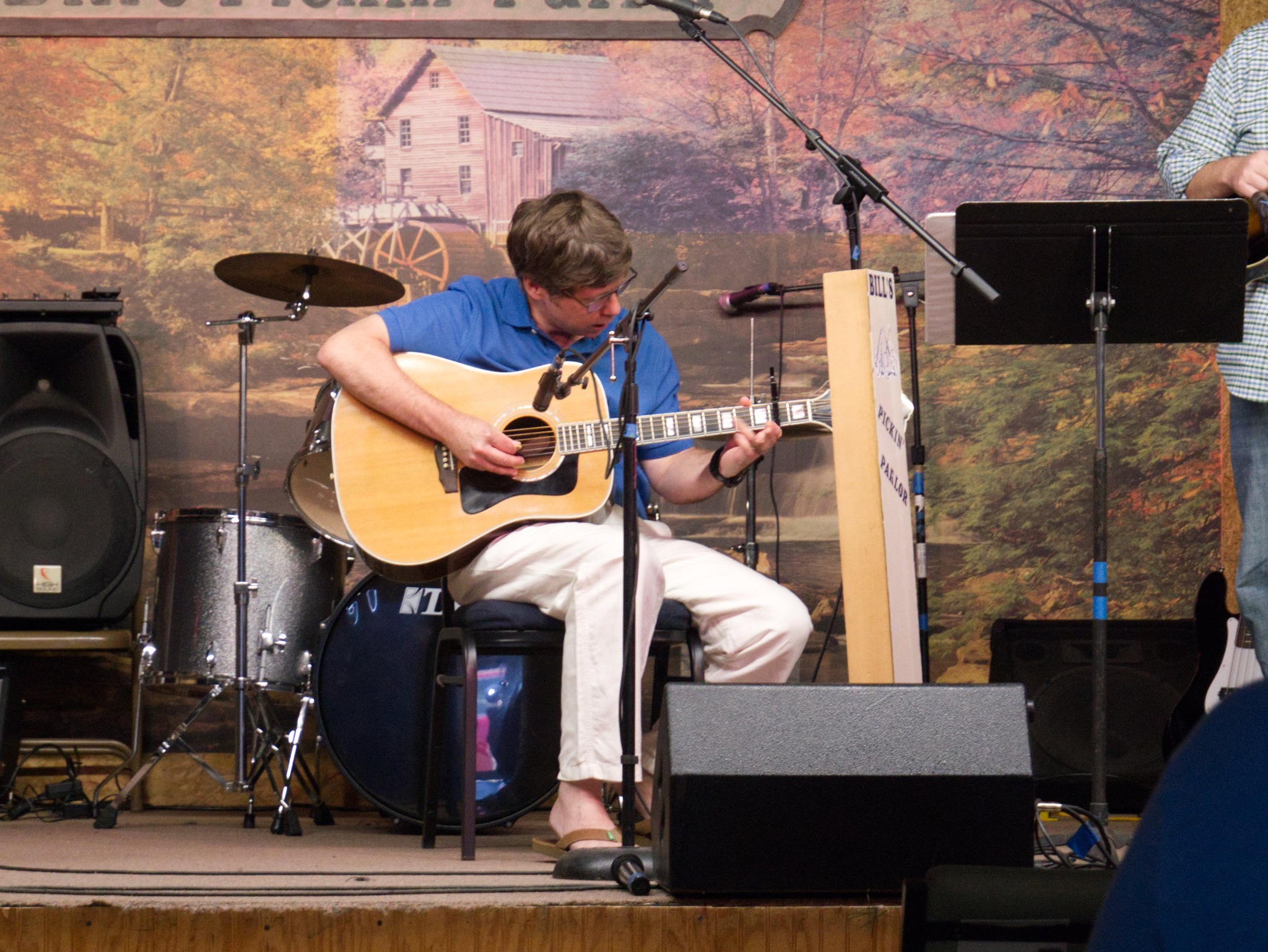 Jim performing with a guitar student