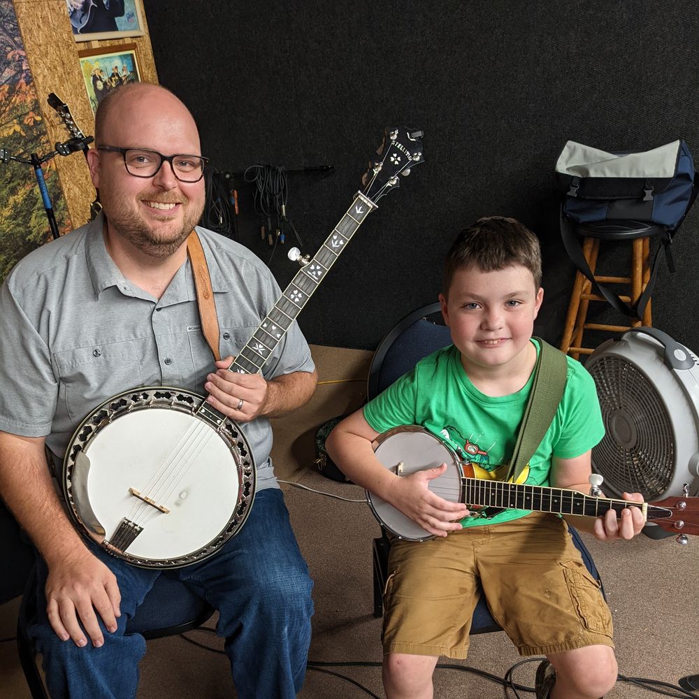 Jim Morgan with a student during a banjo lesson.