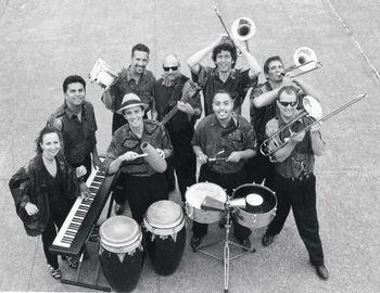 Also by the great photographer Irene Young, another fun photo from the same 1999 session for "Madre Rumba, Padre Son" CD. Front Row (L to R): Sandy Cressman, Edgardo Cambón, Julio Areas, John Gove. Back (L to R) Ben Heveroh, Eric Rangel, David Belove, Jeff Cressman and Marty Wehner.
