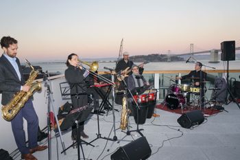 Rooftop event. In San Francisco, with the Bay Bridge behind.
