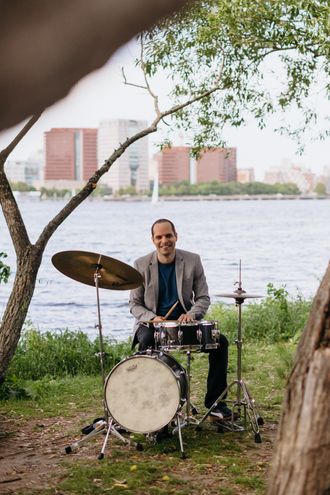 Dor Herskovits with  drums on the Charles river in Boston