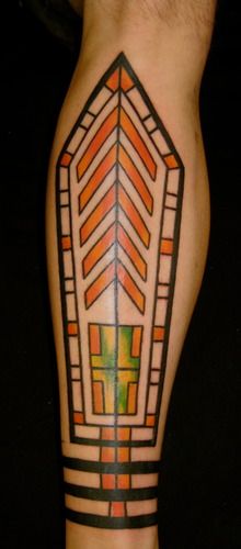 Interpretation of modern stained glass on subject's front lower leg
