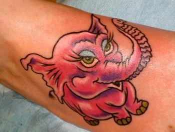 Pink elephant on female arm
