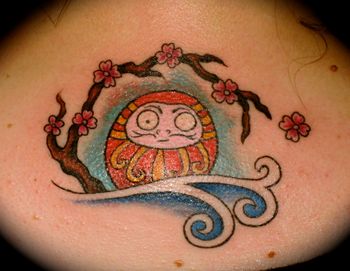 Japanese cartoon character with cherry branch on female upper back
