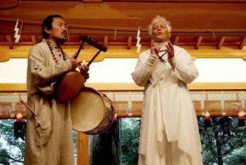 Shizuno helps me dress all in white, a costume from Kaoriko in Hawaii. So beautiful and formal for this occasion. I feel like I am being married. Strange but sweet. We enter the temple by using the water at the gate. There is a small dipper which we use to wash left and right hands, then sip and spit out the water, then let the water run down the length of the handle and then replace at the pool of water. We E Ho Mai at the bridge to bring Hawaii to this ceremony. The ceremony at the temple is full of horns, bells and chanting, costumes and walking up and down remembering what holds life together. Honoring this season. That’s what I think it is about. Much of the time, I don’t know at all what is being said and must be content to follow and respond the best I can.
