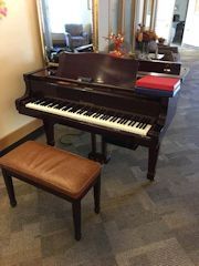 This is a Bergmann TG-157 grand piano. Actually just a subsidiary line of Young Chang. Bergmann production began around 1997. This instrument was built in China in the year 2001.
