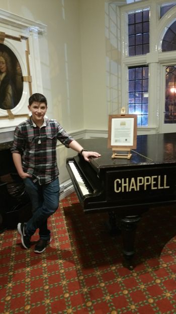 Jake with a piano in the lobby of the Hind Hotel, in Wellingborough, England. The piano had previously been played by Paul McCartney and Freddie Mercury.
