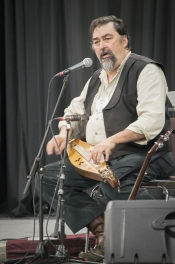 Dave with the Mountain Dulcimer playing for the Parliament of world Religions on the Gathering Space stage.
