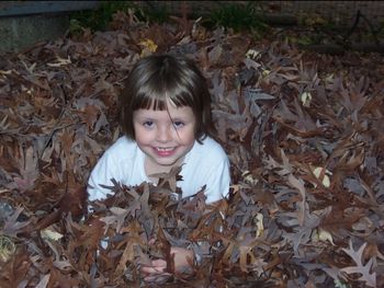 Christina in a pile of leaves A good fall photo
