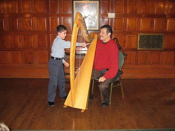 St. Paul, MN Scottish Ramble 2010 Reuben invites children to strum his harp at the Landmark Center
