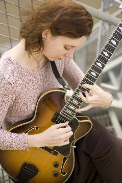 Margaret playing her arch-top electric guitar, made by Portland luthier Saul Koll; photo by Hiroshi Iwaya
