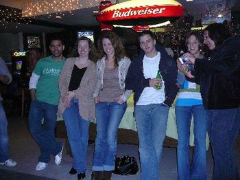 Jay's family pose at the pool table.
