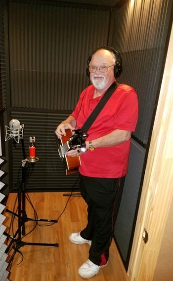 Rick Ford tracking acoustic guitar in the booth.
