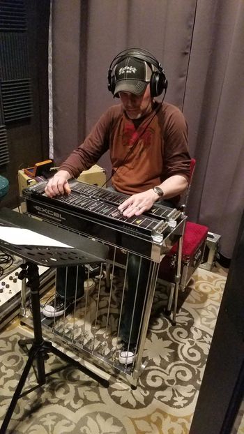 Mark Huhta laying a steel guitar track.
